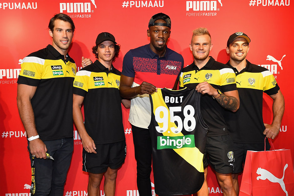 AFL 2017 Media - Richmond Tigers With Usain Bolt MELBOURNE, AUSTRALIA - FEBRUARY 07: Alex Rance, Daniel Rioli, Brandon Ellis and Sam Lloyd of the Tigers present Usain Bolt of Jamaica with a guernsey during a Richmond Tigers AFL media opportunity at Melbourne Central Shopping Centre on February 7, 2017 in Melbourne, Australia. (Photo by Quinn Rooney/Getty Images)