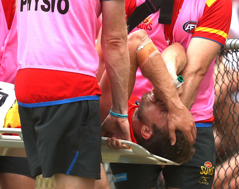 AFL 2017 JLT Community Series - Gold Coast v Brisbane MERRIMAC, AUSTRALIA - FEBRUARY 19: Sam Day of the Suns leaves the ground injured during the AFL 2017JLT Community Series match between the Gold Coast Suns and the Brisbane Lions at Kombumerri Park on February 19, 2017 in Merrimac, Australia. (Photo by Sean Garnsworthy/AFL Media)