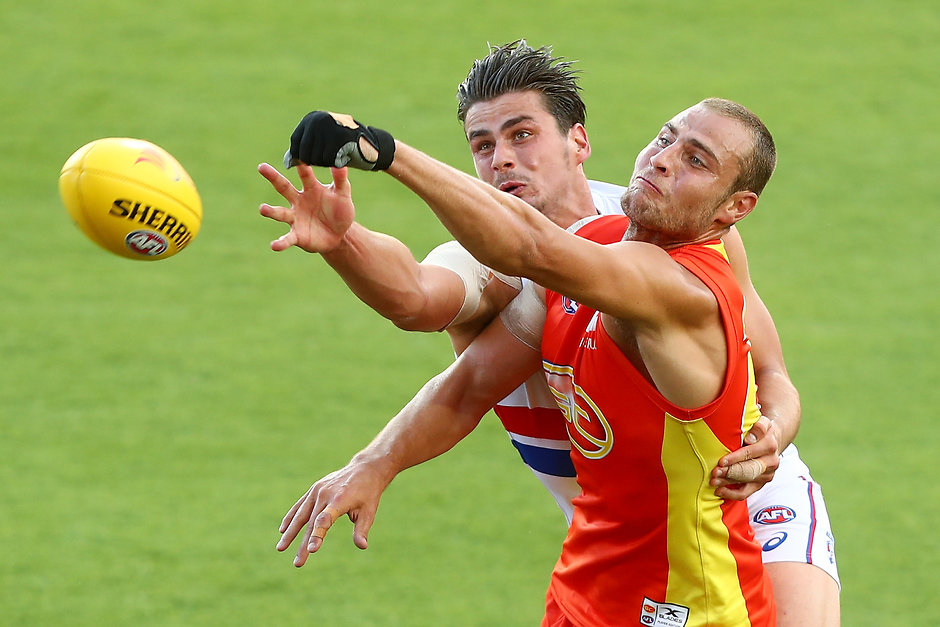 AFL 2017 JLT Community Series - Gold Coast Suns v Western Bulldogs GOLD COAST, AUSTRALIA - MARCH 09: Tom Boyd of the Bulldogs and Jarrod Witts of the Suns compete for the ball during the JLTR Community Series AFL match between the Gold Coast Suns and the Western Bulldogs at Metricon Stadium on March 9, 2017 in Gold Coast, Australia. (Photo by Chris Hyde/Getty Images)