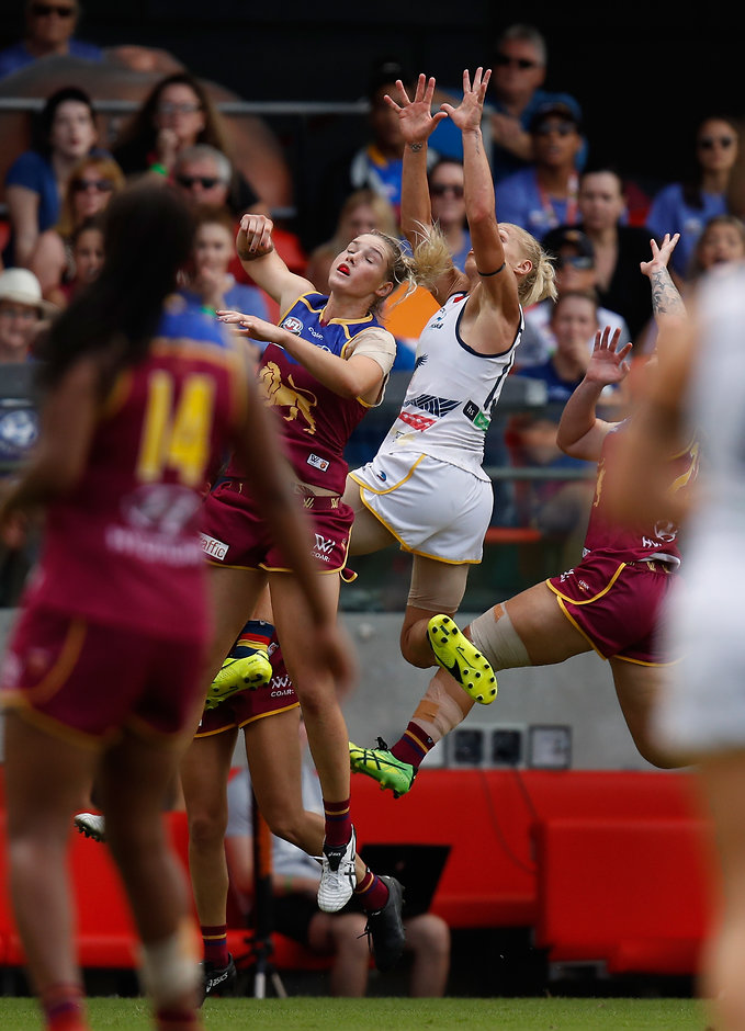 AFLW 2017 Grand Final - Brisbane v Adelaide GOLD COAST, AUSTRALIA - MARCH 25: Erin Phillips of the Crows takes a spectacular mark over Tayla Harris of the Lions during the 2017 AFLW Grand Final match between the Brisbane Lions and the Adelaide Crows at Metricon Stadium on March 25, 2017 in Gold Coast, Australia. (Photo by Michael Willson/AFL Media)