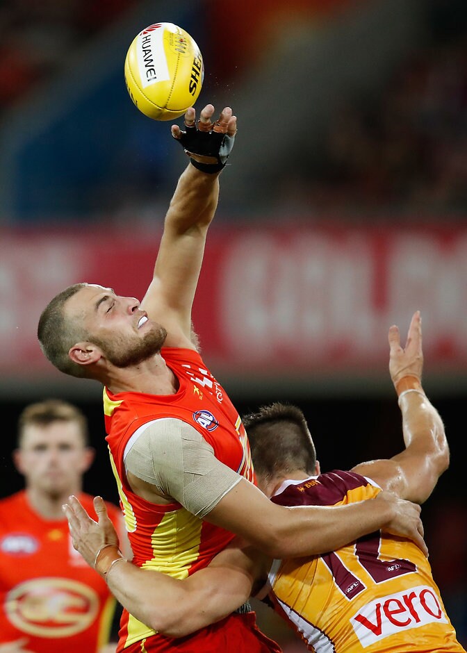 AFL 2017 Round 01 - Gold Coast v Brisbane GOLD COAST, AUSTRALIA - MARCH 25: Jarrod Witts of the Suns and Stefan Martin of the Lions compete for the ball during the 2017 AFL round 01 match between the Gold Coast Suns and the Brisbane Lions at Metricon Stadium on March 25, 2017 in Gold Coast, Australia. (Photo by Michael Willson/AFL Media)