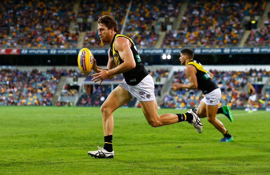 AFL 2017 Round 04 - Brisbane Lions v Richmond BRISBANE, AUSTRALIA - APRIL 16: Reece Conca of the Tigers runs with the ball during the 2017 AFL round 04 match between the Brisbane Lions and the Richmond Tigers at the Gabba on April 16, 2017 in Brisbane, Australia. (Photo by Jason O'Brien/AFL Media)