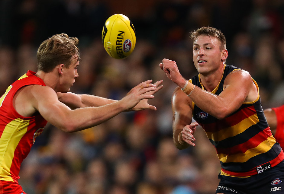 AFL 2018 Round 06 - Adelaide v Gold Coast ADELAIDE, AUSTRALIA - APRIL 28: Daniel Talia of the Crows handpasses the ball past Tom Lynch of the Suns during the 2018 AFL round six match between the Adelaide Crows and the Gold Coast Suns at Adelaide Oval on April 28, 2018 in Adelaide, Australia. (Photo by AFL Media)
