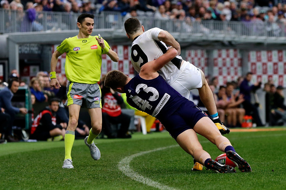 AFL 2018 Round 17 - Fremantle v Port Adelaide PERTH, AUSTRALIA - JULY 15: Robbie Gray of the Power is tackled by Ryan Nyhuis of the Dockers during the 2018 AFL round 17 match between the Fremantle Dockers and the Port Adelaide Power at Optus Stadium on July 15, 2018 in Perth, Australia. (Photo by Will Russell/AFL Media)