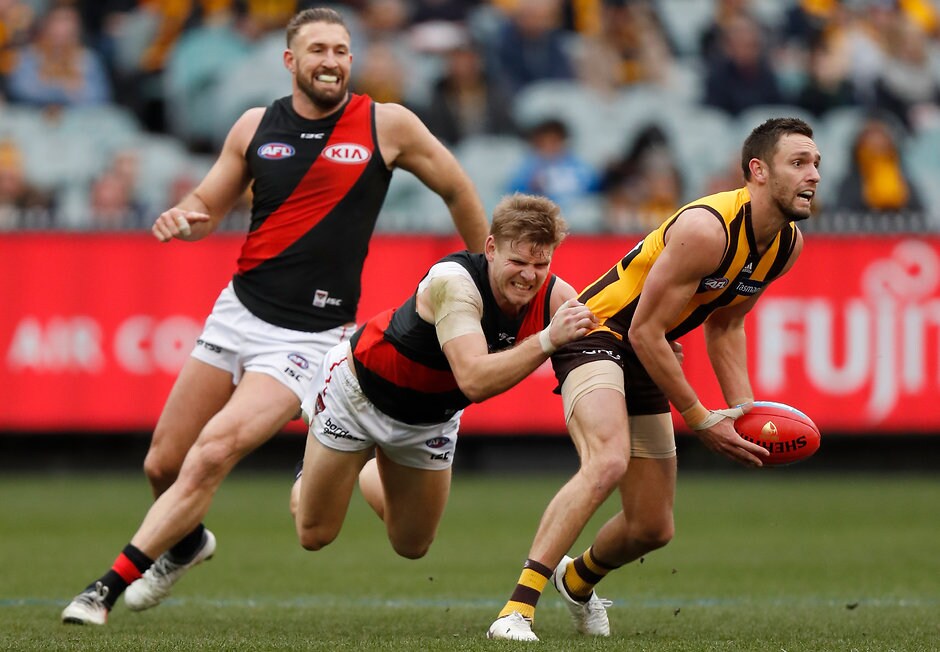 AFL 2018 Round 20 - Hawthorn v Essendon MELBOURNE, AUSTRALIA - AUGUST 04: Jack Gunston of the Hawks is tackled by Michael Hurley of the Bombers during the 2018 AFL round 20 match between the Hawthorn Hawks and the Essendon Bombers at the Melbourne Cricket Ground on August 04, 2018 in Melbourne, Australia. (Photo by Michael Willson/AFL Media)