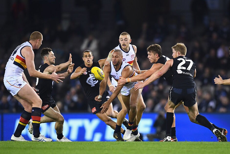 AFL 2018 Round 23 - Carlton v Adelaide MELBOURNE, AUSTRALIA - AUGUST 25: Cam Ellis-Yolmen of the Crows handballs whilst being tackled during the round 23 AFL match between the Carlton Blues and the Adelaide Crows at Etihad Stadium on August 25, 2018 in Melbourne, Australia. (Photo by Quinn Rooney/Getty Images/AFL Media)