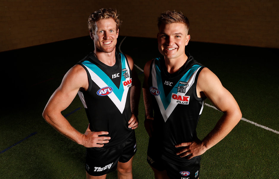 AFL 2019 Portraits - Port Adelaide ADELAIDE, AUSTRALIA - FEBRUARY 27: 2019 Port Adelaide co-captains Tom Jonas (left) and Ollie Wines (right) pose for a photograph during the Port Adelaide Power 2019 official team photo day at Alberton on February 27, 2019 in Adelaide, Australia. (Photo by Michael Willson/AFL Media)
