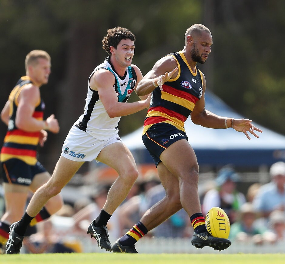 AFL 2019 JLT Community Series - Adelaide v Port Adelaide ADELAIDE, AUSTRALIA - MARCH 02 : Cameron Ellis-Yolmen of the Crows kicks the ball in front of Darcy Byrne-Jones of the Power during the 2019 JLT Community Series match between the Adelaide Crows and the Port Adelaide Power at Memorial Oval on March 02, 2019 in Adelaide, Australia. (Photo by AFL Media)