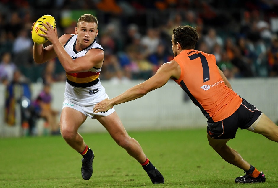 AFL 2019 JLT Community Series - GWS v Adelaide CANBERRA, AUSTRALIA - MARCH 08: Rory Laird of the Crows is tackled during the 2019 JLT Community Series AFL match between the Greater Western Sydney Giants and the Adelaide Crows at UNSW Canberra Oval on March 08, 2019 in Canberra, Australia. (Photo by Tracey Nearmy/Getty Images)