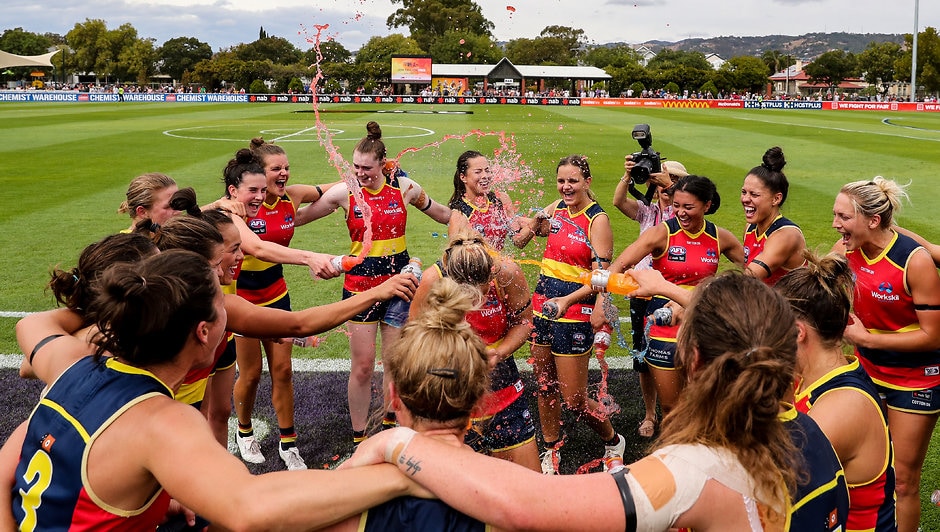 AFLW 2019 Round 06 - Adelaide v GWS ADELAIDE, AUSTRALIA - MARCH 10: Crows players celebrate victory with Nikki Gore in the middle during the 2019 NAB AFLW Round 06 match between the Adelaide Crows and the GWS Giants at Unley Oval on March 10, 2019 in Adelaide, Australia. (Photo by AFL Media)