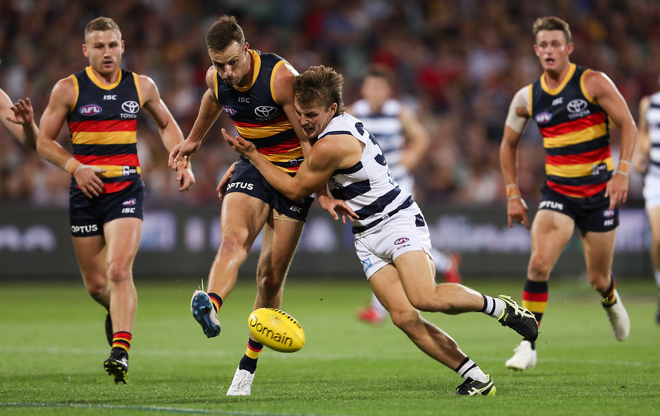 AFL 2019 Round 03 - Adelaide v Geelong ADELAIDE, AUSTRALIA - APRIL 04: Tom Atkins of the Cats and Brodie Smith of the Crows compete for the ball during the 2019 AFL round 03 match between the Adelaide Crows and the Geelong Cats at Adelaide Oval on April 04, 2019 in Adelaide, Australia. (Photo by AFL Photos)