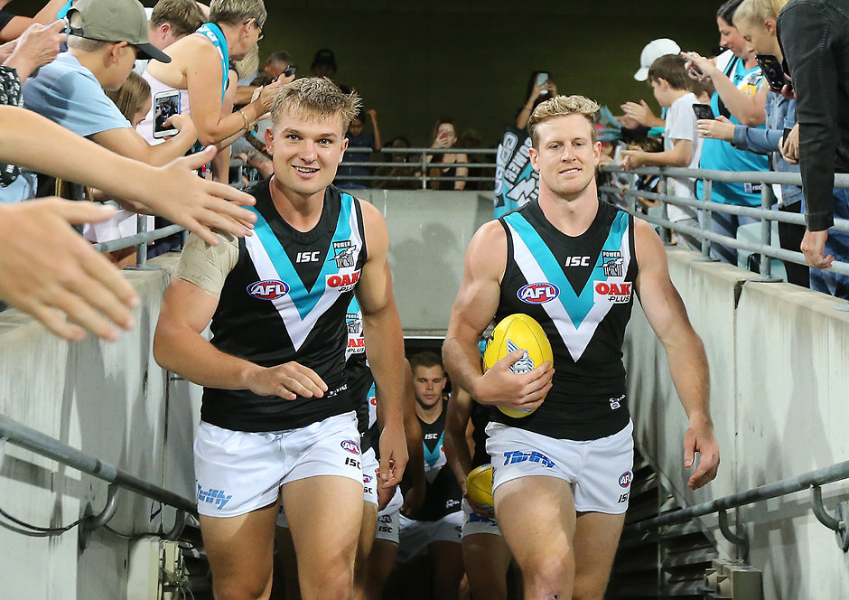 AFL 2019 Round 03 - Brisbane v Port Adelaide BRISBANE, AUSTRALIA - APRIL 06: Port Adelaide Co-Captains Ollie Wines and Tom Jonas lead their team during the 2019 AFL round 03 match between the Brisbane Lions and the Port Adelaide Power at The Gabba on April 06, 2019 in Brisbane, Australia. (Photo by Jono Searle/AFL Photos)