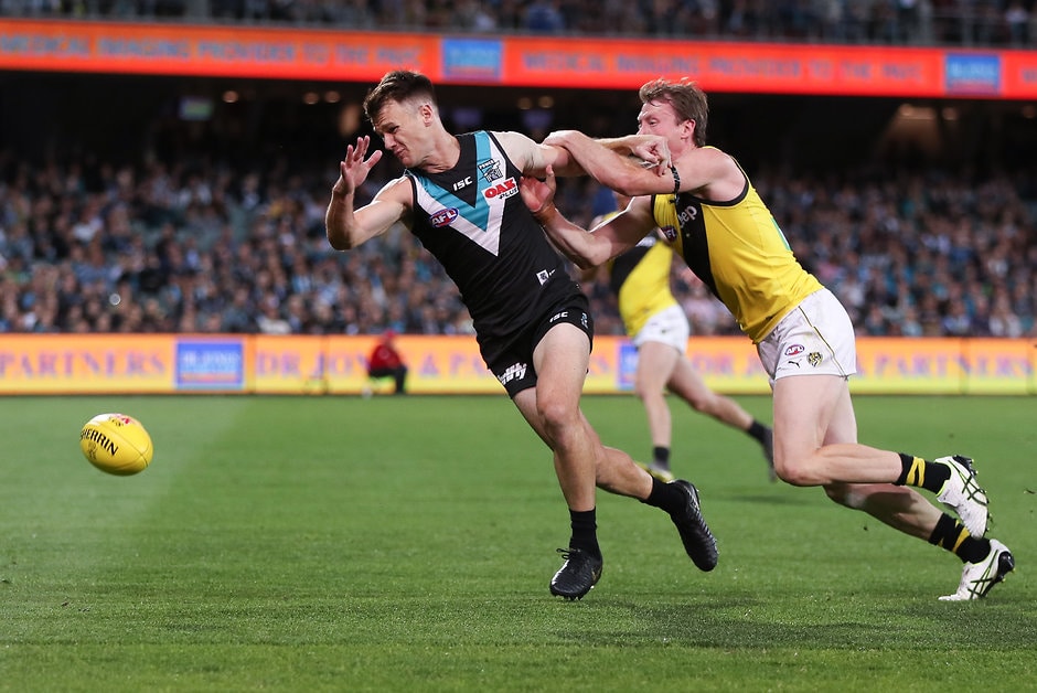 AFL 2019 Round 04 - Port Adelaide v Richmond ADELAIDE, AUSTRALIA - APRIL 13: Robbie Gray of the Power is held by Dylan Grimes of the Tigers during the 2019 AFL round 04 match between the Port Adelaide Power and the Richmond Tigers at Adelaide Oval on April 13, 2019 in Adelaide, Australia. (Photo by AFL Photos)