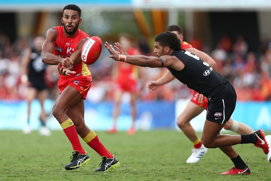 AFL 2019 Round 04 - Gold Coast v Carlton GOLD COAST, AUSTRALIA - APRIL 14: Touk Miller of the Suns handballs during the round four AFL match between the Gold Coast Suns and the Carlton Blues at Metricon Stadium on April 14, 2019 in Gold Coast, Australia. (Photo by Chris Hyde/Getty Images)