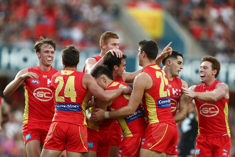 AFL 2019 Round 04 - Gold Coast v Carlton Jack Bowes is mobbed by teammates after snagging a goal during the R4 clash between Gold Coast and Carlton - Gold Coast Suns,AFL,Exclusive,Tag-Exclusive