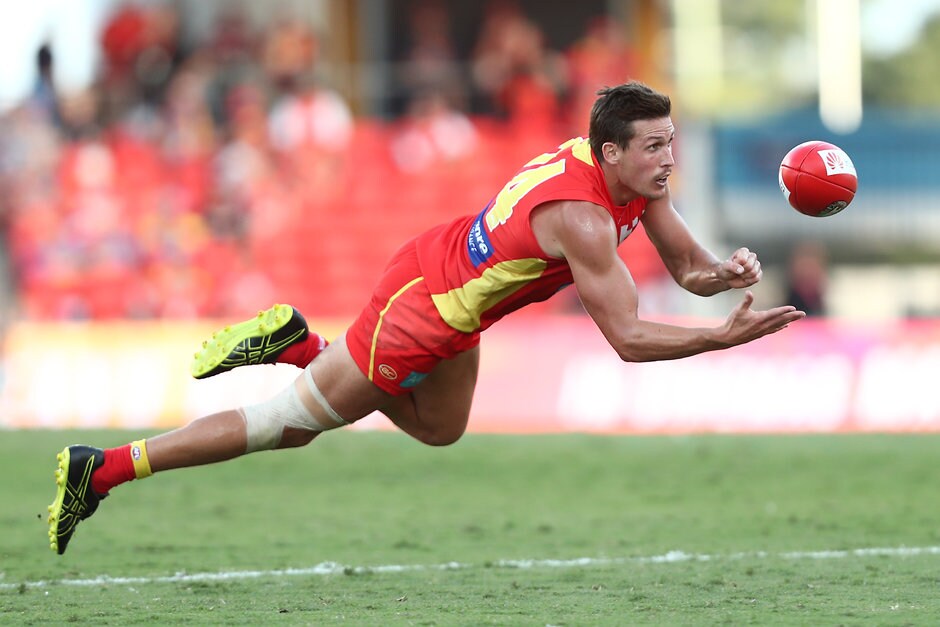 AFL 2019 Round 06 - Gold Coast v Brisbane GOLD COAST, AUSTRALIA - APRIL 27: David Swallow of the Suns handballs during the round 6 AFL match between Gold Coast and Brisbane at Metricon Stadium on April 27, 2019 in Gold Coast, Australia. (Photo by Chris Hyde/Getty Images)