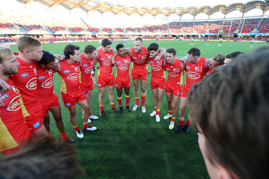 AFL 2019 Round 08 - Gold Coast v Melbourne GOLD COAST, AUSTRALIA - MAY 11: Jarrod Witts (center) of the Suns talks to his team during the round eight AFL match between the Gold Coast Suns and the Melbourne Demons at Metricon Stadium on May 11, 2019 in Gold Coast, Australia. (Photo by Jono Searle/AFL Photos/Getty Images)