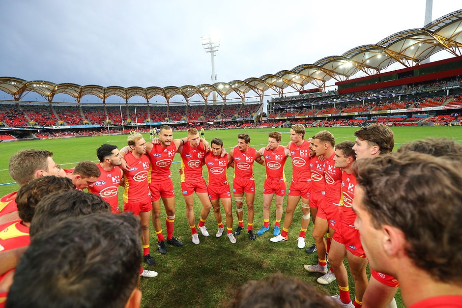 AFL 2019 Round 12 - Gold Coast v North Melbourne GOLD COAST, AUSTRALIA - JUNE 08: The Suns get in a huddle before the round 12 AFL match between the Gold Coast Suns and the North Melbourne Kangaroos at Metricon Stadium on June 08, 2019 in Gold Coast, Australia. (Photo by Jono Searle/AFL Photos/Getty Images)