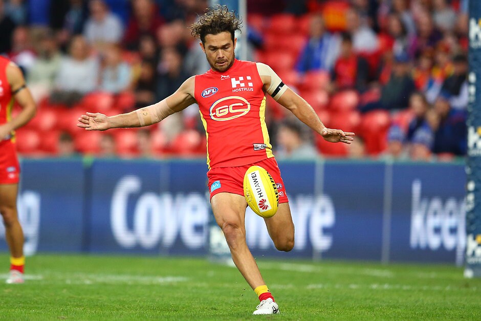 AFL 2019 Round 12 - Gold Coast v North Melbourne GOLD COAST, AUSTRALIA - JUNE 08: Jarrod Harbrow of the Suns kicks the ball during the round 12 AFL match between the Gold Coast Suns and the North Melbourne Kangaroos at Metricon Stadium on June 08, 2019 in Gold Coast, Australia. (Photo by Jono Searle/AFL Photos/Getty Images)