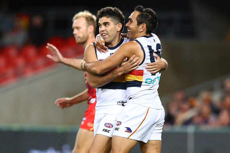 AFL 2019 Round 17 - Gold Coast v Adelaide GOLD COAST, AUSTRALIA - JULY 13: Tyson Stengle of the Crows celebrates his goal with team mate Eddie Betts during the round 17 AFL match between the Gold Coast Suns and the Adelaide Crows at Metricon Stadium on July 13, 2019 in Gold Coast, Australia. (Photo by Jono Searle/AFL Photos)