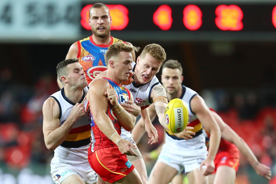 AFL 2019 Round 17 - Gold Coast v Adelaide GOLD COAST, AUSTRALIA - JULY 13: Darcy Macpherson of the Suns is tackled during the round 17 AFL match between the Gold Coast Suns and the Adelaide Crows at Metricon Stadium on July 13, 2019 in Gold Coast, Australia. (Photo by Chris Hyde/Getty Images via AFL Photos)