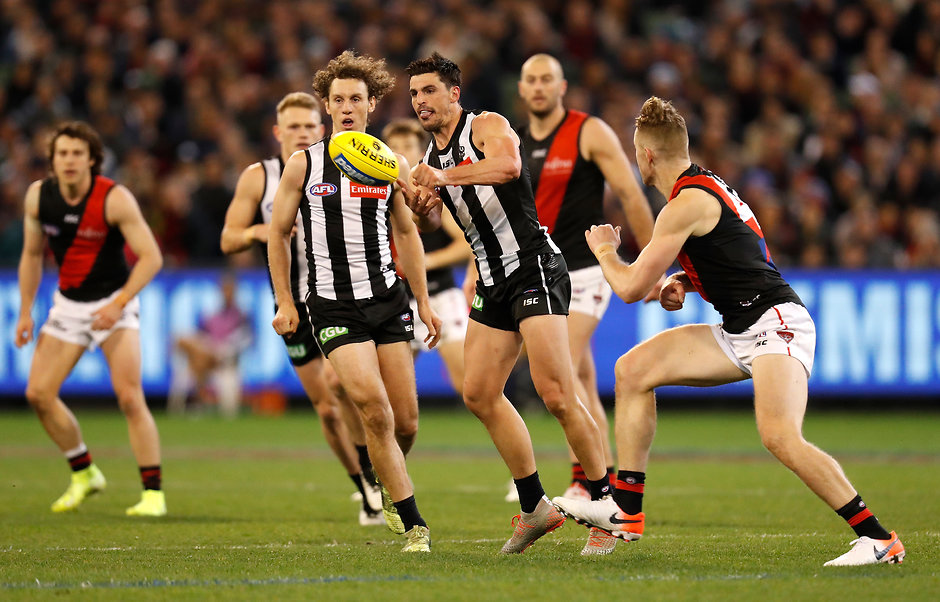 AFL 2019 Round 23 - Collingwood v Essendon Scott Pendlebury gets a handball away during the Pies' win over the Bombers - Collingwood Magpies,Essendon Bombers